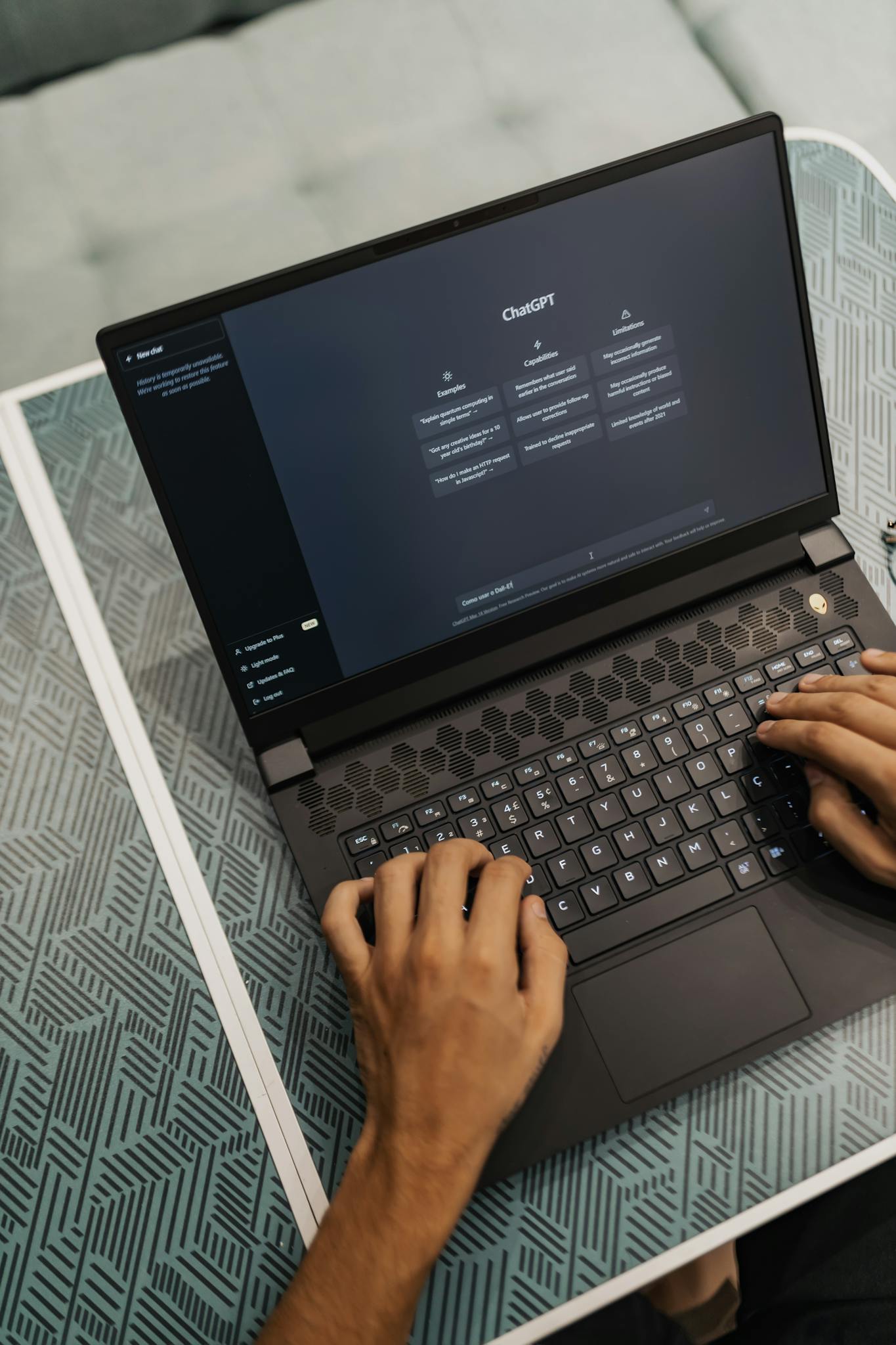 Person typing on a laptop with ChatGPT displayed, showcasing modern technology use.